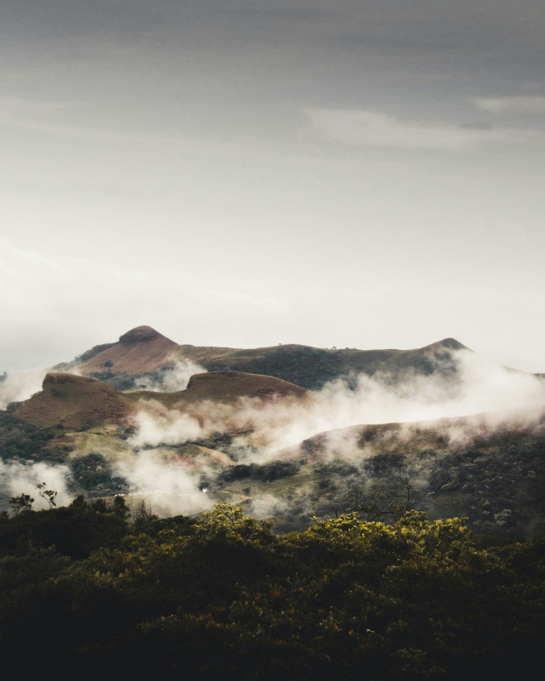 a-view-of-a-mountain-range-covered-in-clouds-8z4is8tce9g